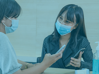 nurse talking to patient wearing masks